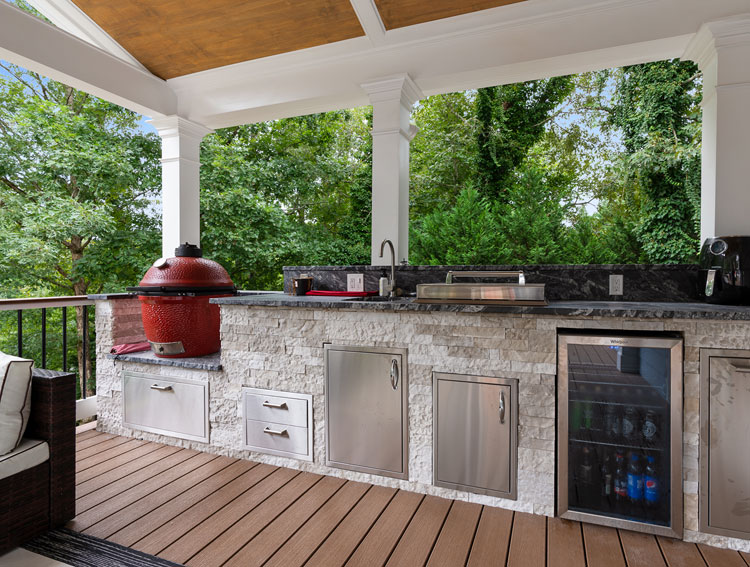Outdoor kitchen area, with fridge, sink and cooker.