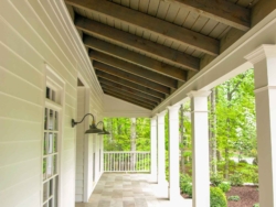 New front porch with tile floor and cedar beams exposed rafters