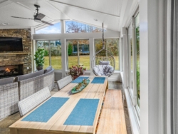 New sun room with furniture and patio and fireplace