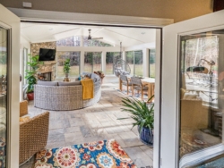 Sun room with furniture, patio and fireplace